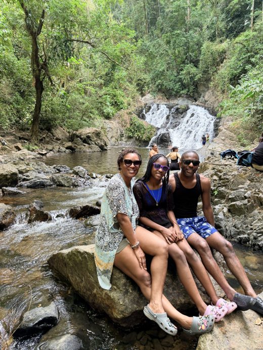 The Thomas family together at a waterfall